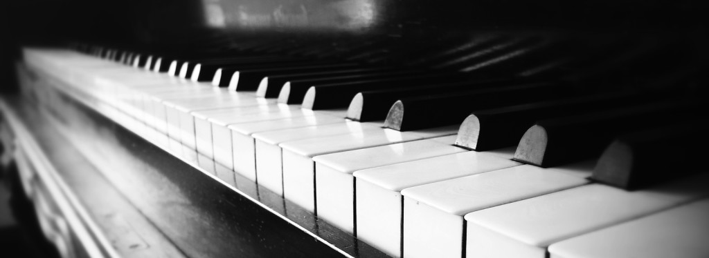 A close up of the keys of an antique piano